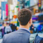 Businessman walking the streets with shoulder bag