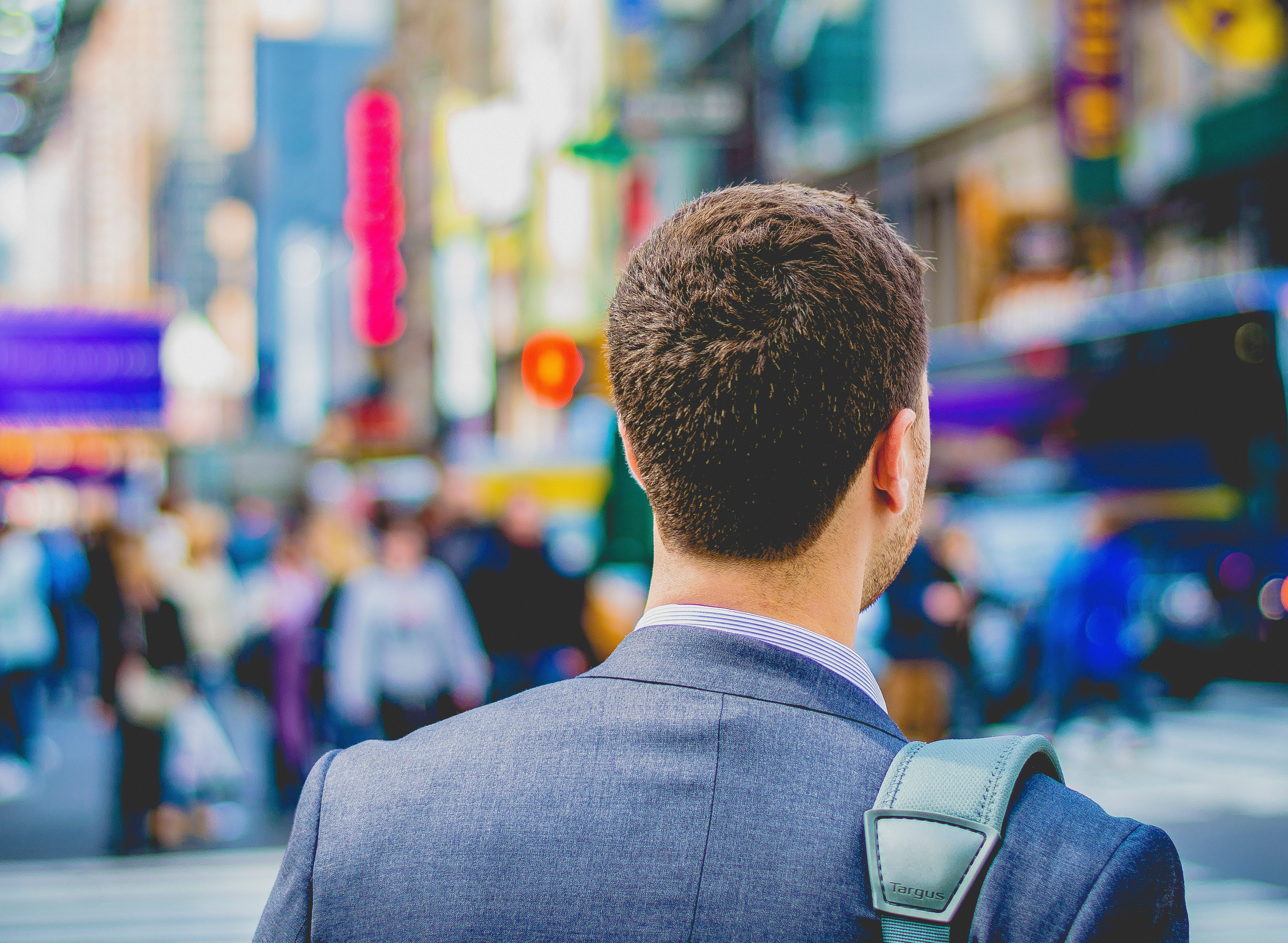 Businessman walking the streets with shoulder bag